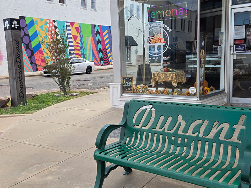 Image of a Bench in front of a storefront on Main Street Durant